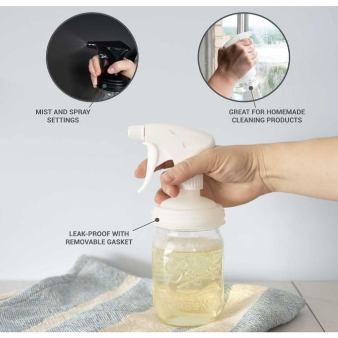 Hand pressing white sprayer lid with adjustable mist and spray settings on a regular-mouth mason jar filled with liquid, featuring a leak-proof gasket, ideal for eco-friendly homemade cleaning, part of Home & Decor, Household Helpers, USA Made, Best Sellers, and Promo Eligible collections.