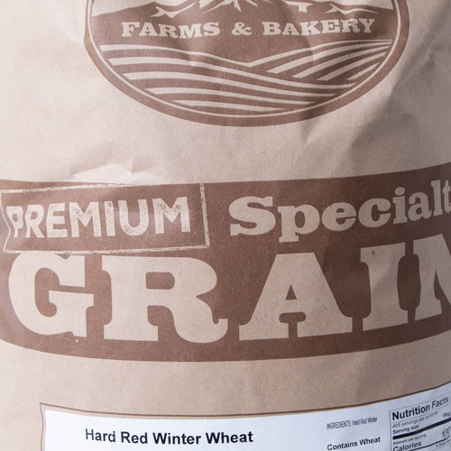 Close-up of a handcrafted brown paper bag labeled for premium hard red winter wheat grain, highlighting its suitability for baking and milling, featured in Farm, Garden & Tool, Pantry, and USA Made collections.