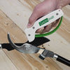Handheld garden tool sharpener with white body and green handle, designed to quickly sharpen pruning shears and other farm and garden tools, crafted in the USA for lawncare and best sellers collections.