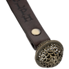 Close-up of a handcrafted antique-style brass bell with a filigree pattern, attached to a brown leather strap engraved with a reindeer's name, for Home & Decor, Holiday Decor, Best Sellers, Promo Eligible, Sale collections.
