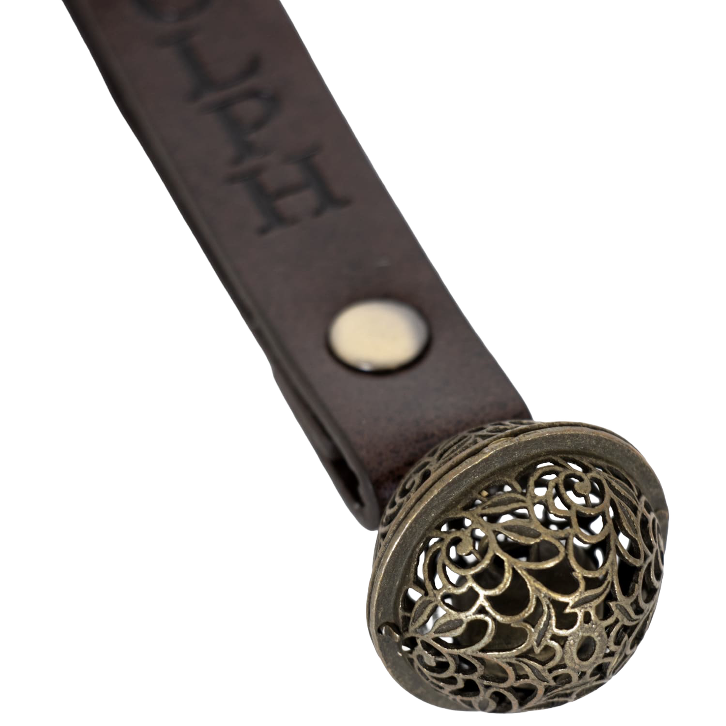 Close-up of a handcrafted antique-style brass bell with a filigree pattern, attached to a brown leather strap engraved with a reindeer's name, for Home & Decor, Holiday Decor, Best Sellers, Promo Eligible, Sale collections.