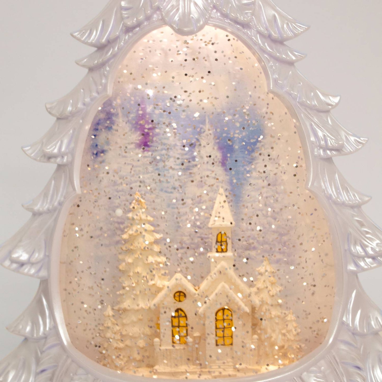 Lighted tree-shaped water globe featuring a snowy church surrounded by pine trees with shimmering snow effect and a 6-hour timer, ideal for Home & Decor and Holiday Decor collections.
