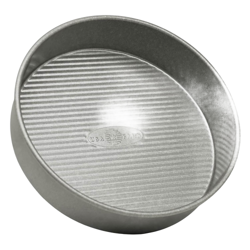 Round 9-inch aluminized steel cake pan with a unique fluted surface for even baking and nonstick performance, featured in Kitchen & Food and USA Made collections.