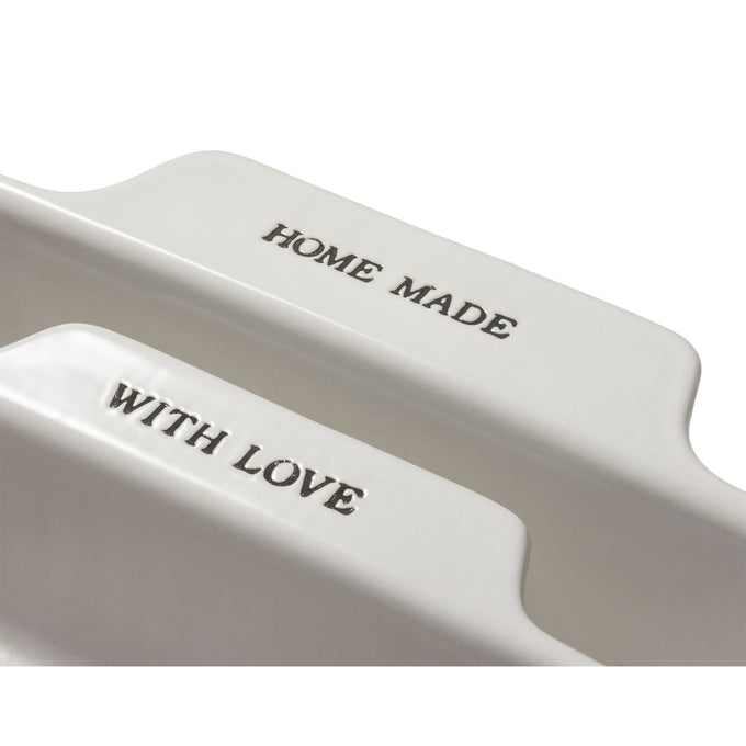 Close-up of a set of two handcrafted neutral-colored stoneware baking dishes with embossed “HOME MADE” and “WITH LOVE” text, ideal for Kitchen & Food and Baking Supplies collections.