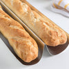 Two golden crusty baguettes freshly baked in lightweight heavy gauge tinplate steel pans designed for professional quality bread making in Kitchen & Food collections.