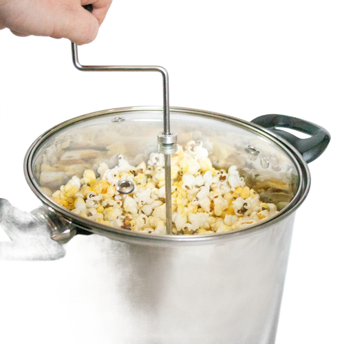 Stainless steel stovetop popcorn popper with glass lid, black handles, and hand crank stirring arm, handcrafted for fresh popcorn in Kitchen & Food and Cookware collections.