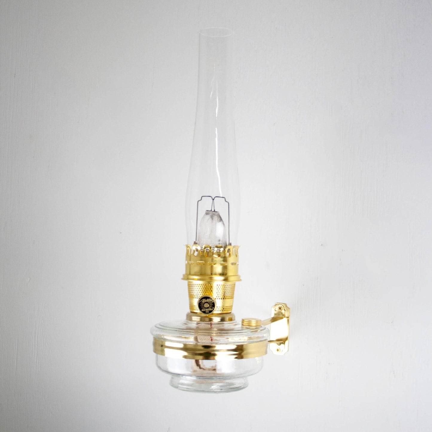 Handcrafted clear wall oil lamp with polished brass burner and chimney, designed for space-saving wall lighting in Farm, Garden & Tool, Lamps & Lighting, and Emergency Supplies collections.