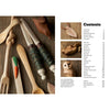 Close-up of handcrafted wooden whittling tools and carved utensils displayed on a rustic surface alongside a detailed contents page from a woodworking book, featured in Toys, Books & Games, Books, Home and Garden How-To Books, Best Sellers, and Promo Eligible collections.