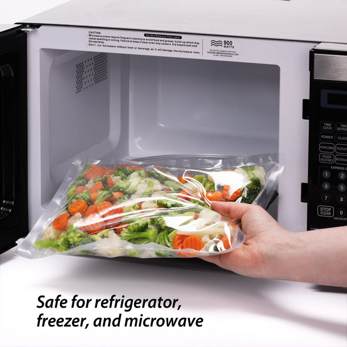 Hand holding a vacuum-sealed bag of mixed vegetables being placed into a microwave, illustrating food preservation and kitchen convenience for freezing, storage, and food safety collections.