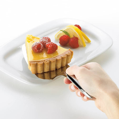 Hand holding a heavy gauge stainless steel pie server serving a slice of lemon tart garnished with raspberries and lemon slices on a white plate, perfect for Kitchen & Food and Storage and Serving collections.