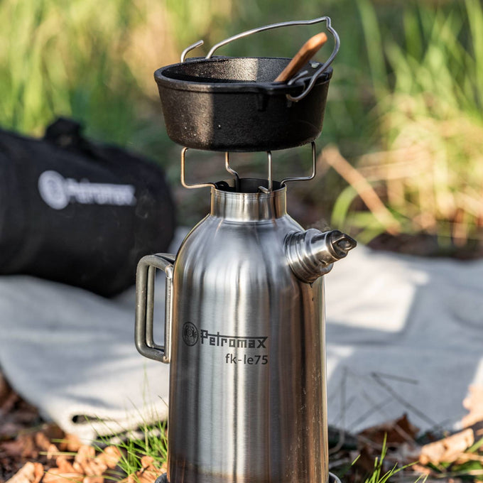 Portable stainless steel fire kettle with screw-on spout and sturdy handle, featuring an outdoor stove base holding a cast iron pot with wooden spoon; ideal for camping, emergency supplies, farm, garden & tool, and best seller collections.