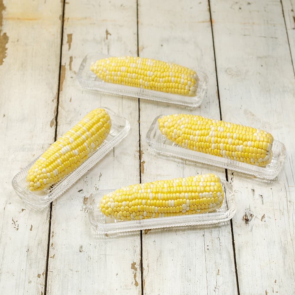 Set of four clear glass dishes designed to hold ears of corn securely while capturing melted butter, handcrafted and featured in Kitchen & Food, Storage and Serving, and Best Sellers collections.