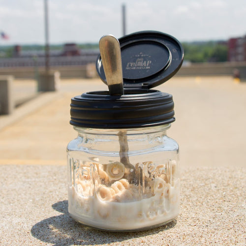 Small glass jar with a black flip top lid partially opened, filled with cereal and milk, handcrafted and made in USA, ideal for kitchen gadgets, storage, and Home & Decor collections.