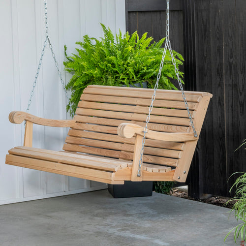 Handcrafted Amish-made cypress porch swing with smooth slats and curved armrests, suspended by metal chains on a covered patio, featured in Home & Decor and Outdoor Furniture collections.