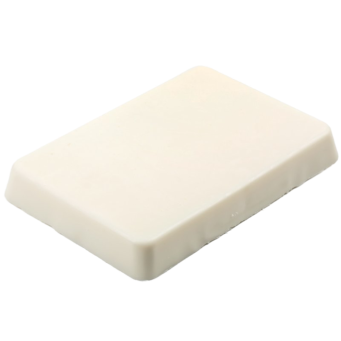 Rectangular block of smooth, off-white soy wax for candlemaking, handcrafted to minimize shrinking and smoke, ideal for use in glass or tin containers in candlemaking supplies.