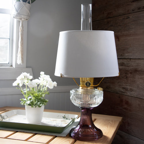 Handcrafted Aladdin parchment shade softly diffusing light over a clear and purple glass oil lamp, perfect for Lamps & Lighting, Lamp Shades, Parts and Accessories, and Best Sellers collections.