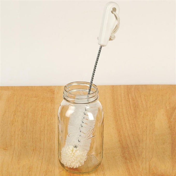 White foam tip cleaning brush with twisted metal handle and hanging loop, shown inside a clear glass jar on a wooden surface, ideal for Home & Decor, Household Cleaning, and USA Made collections.