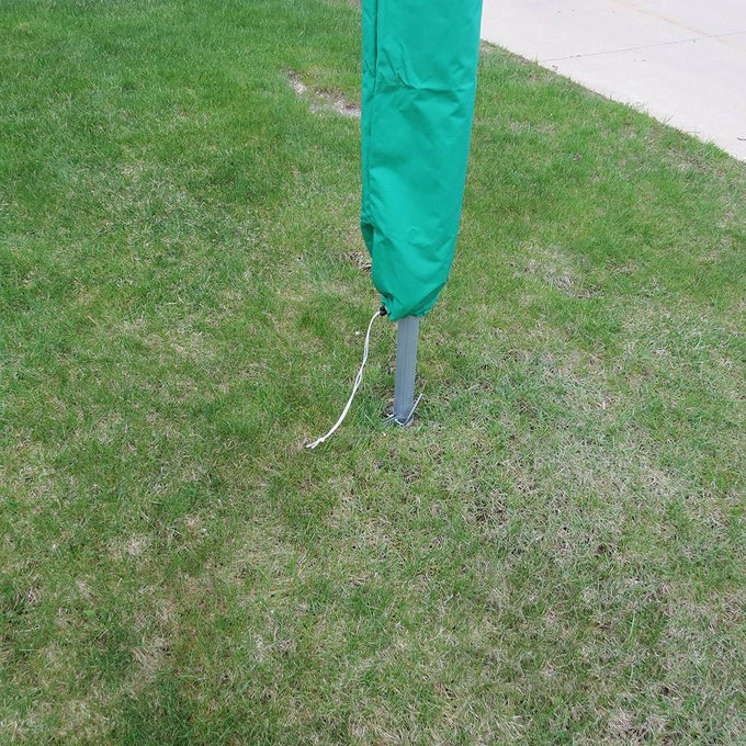 Green weather-resistant protective cover with drawstring closure slipped over clothes dryer pole on lawn, ideal for Home & Decor, Laundry Supplies, and USA Made collections.