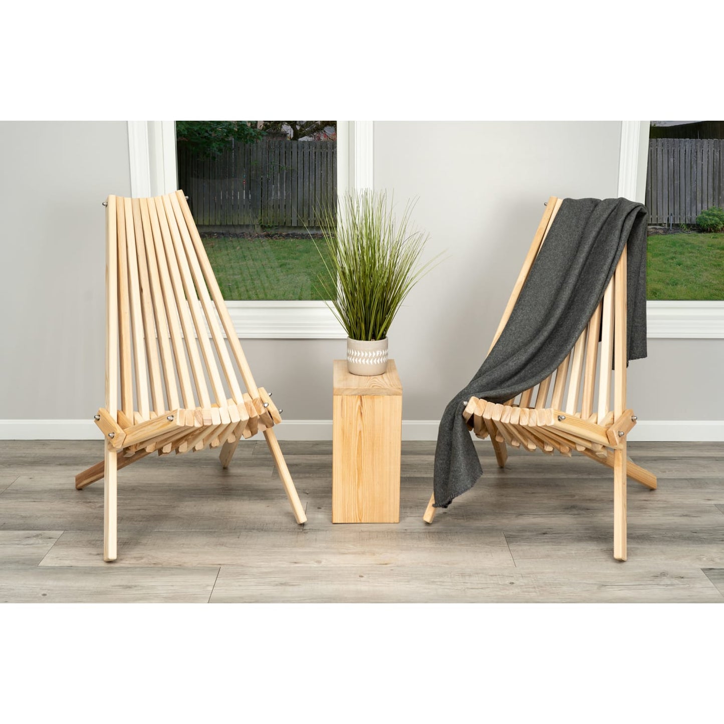Handcrafted cypress wood folding chairs with a sturdy slatted design, shown with a gray throw and decorative plant, featured in Home & Decor, Outdoor Furniture, and Amish Made collections.