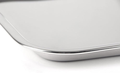 Corner detail of a heavy-duty stainless steel cookie sheet with rust-resistant mirror finish and half-inch edges, ideal for Kitchen & Food and Baking Supplies collections.