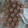 Handcrafted copper-plated cooling grid with a narrow square pattern holding freshly baked chocolate cookies, ideal for Kitchen & Food, Cookware, Baking Supplies, Pots and Pans collections.
