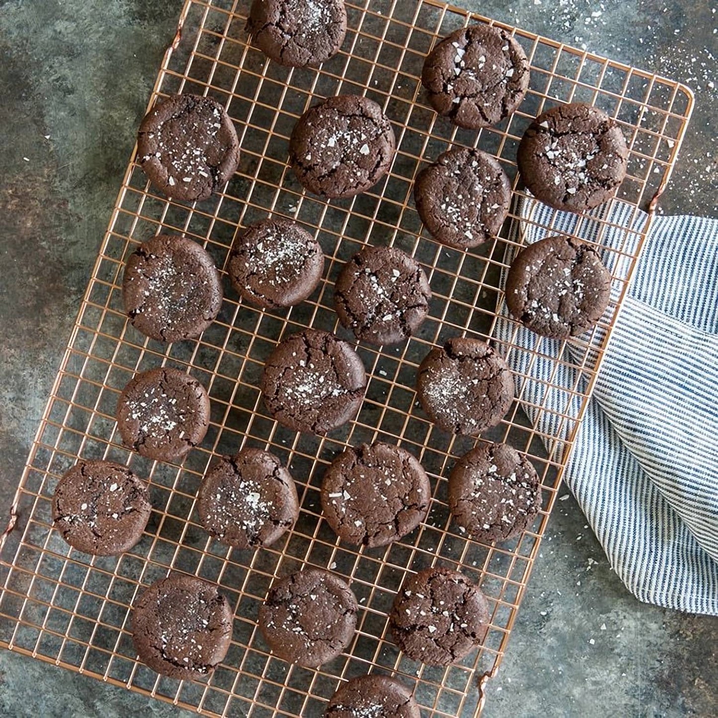 Handcrafted copper-plated cooling grid with a narrow square pattern holding freshly baked chocolate cookies, ideal for Kitchen & Food, Cookware, Baking Supplies, Pots and Pans collections.