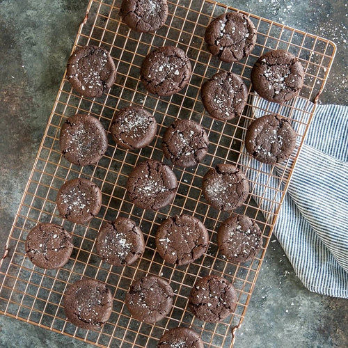 Handcrafted copper-plated cooling grid with a narrow square pattern holding freshly baked chocolate cookies, ideal for Kitchen & Food, Cookware, Baking Supplies, Pots and Pans collections.