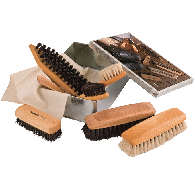 Wooden shoe care set featuring multiple brushes with natural bristles arranged beside a metal storage box and instruction booklet for cleaning and polishing footwear, ideal for cleaning utensils and best sellers collections.