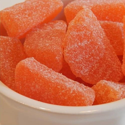 Close-up of bright orange sugar-coated slice candies with a chewy texture, handcrafted in the USA, featured in Kitchen & Food, Snacks and Sweets, Best Sellers, and Promo Eligible collections.