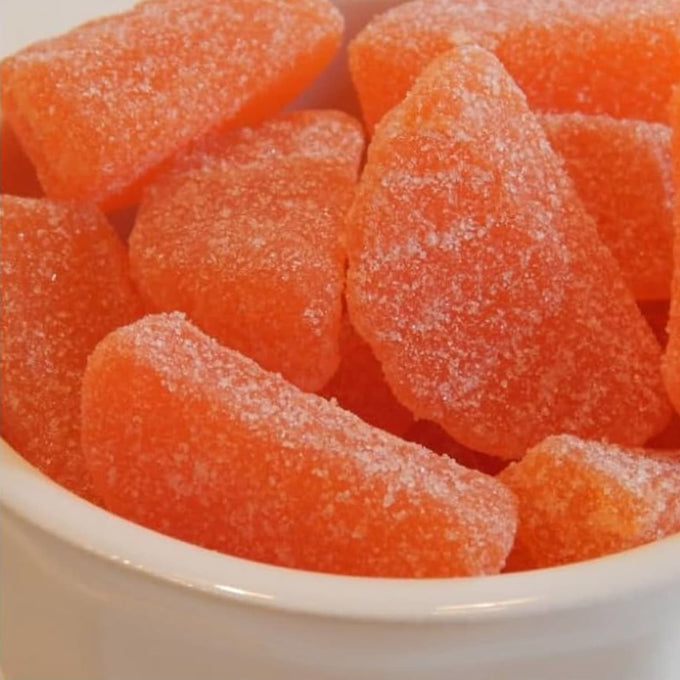 Close-up of bright orange sugar-coated slice candies with a chewy texture, handcrafted in the USA, featured in Kitchen & Food, Snacks and Sweets, Best Sellers, and Promo Eligible collections.