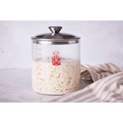 Clear glass sourdough crock with stainless steel lid filled with rising starter, shown with striped cloth, perfect for Kitchen & Food, Cookware, Baking Supplies, and Storage collections.