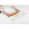 Person rolling dough on a clear non-slip baking mat with multiple crust size guides and measurement gridlines, ideal for Kitchen & Food and Baking Helpers collections.