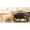 Handcrafted cast iron skillet lid with self-basting tips, seasoned with natural vegetable oil, shown on stovetop with a bowl of popcorn kernels, ideal for Kitchen & Food, Cookware, Cast Iron, Best Sellers, and Promo Eligible collections.