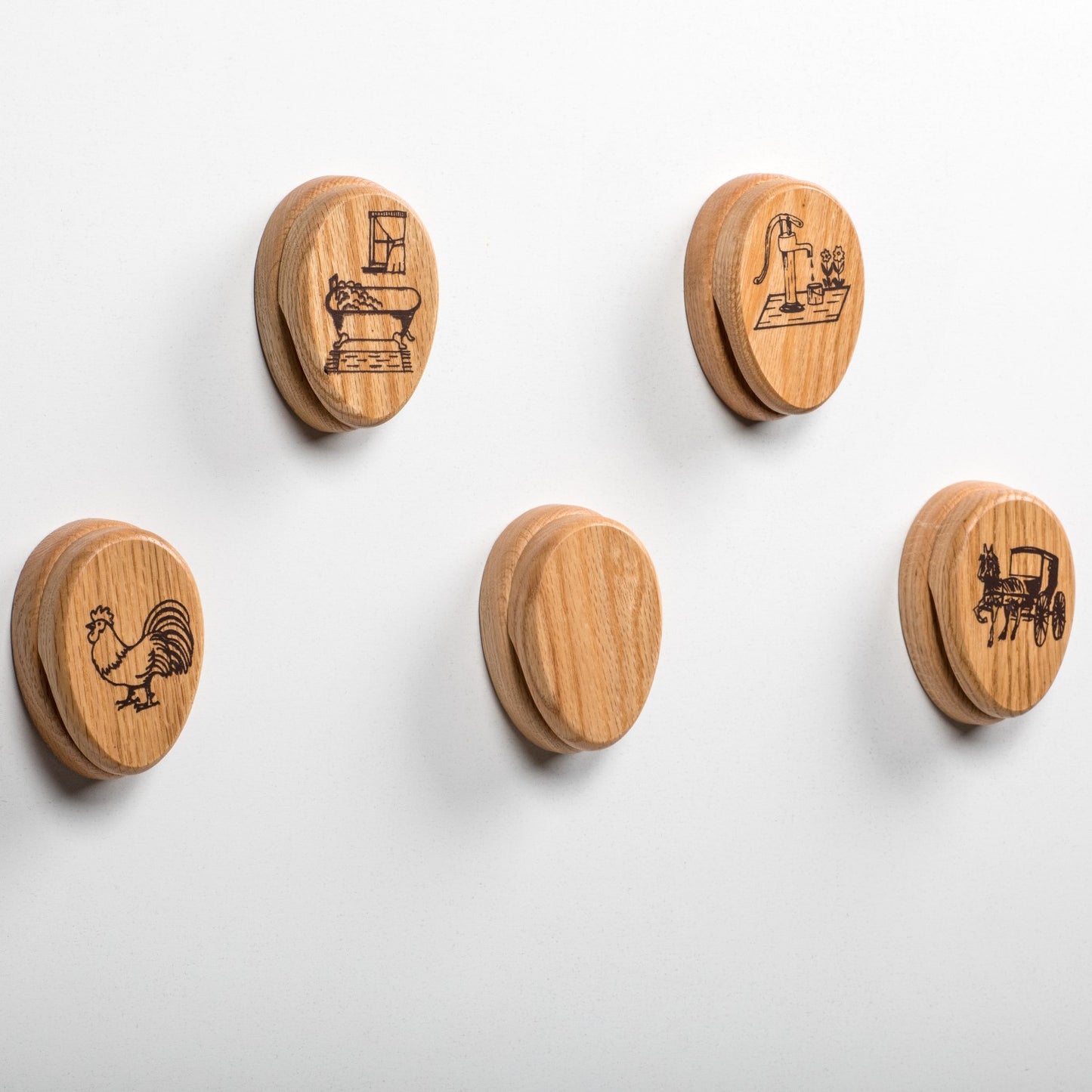 Set of handcrafted oak towel holders with protective clear finish, featuring rustic engraved designs including a rooster, old sewing machine, water pump, and horse-drawn buggy, ideal for Home & Decor, Household Helpers, USA Made, Amish Made, and Best Sellers collections.