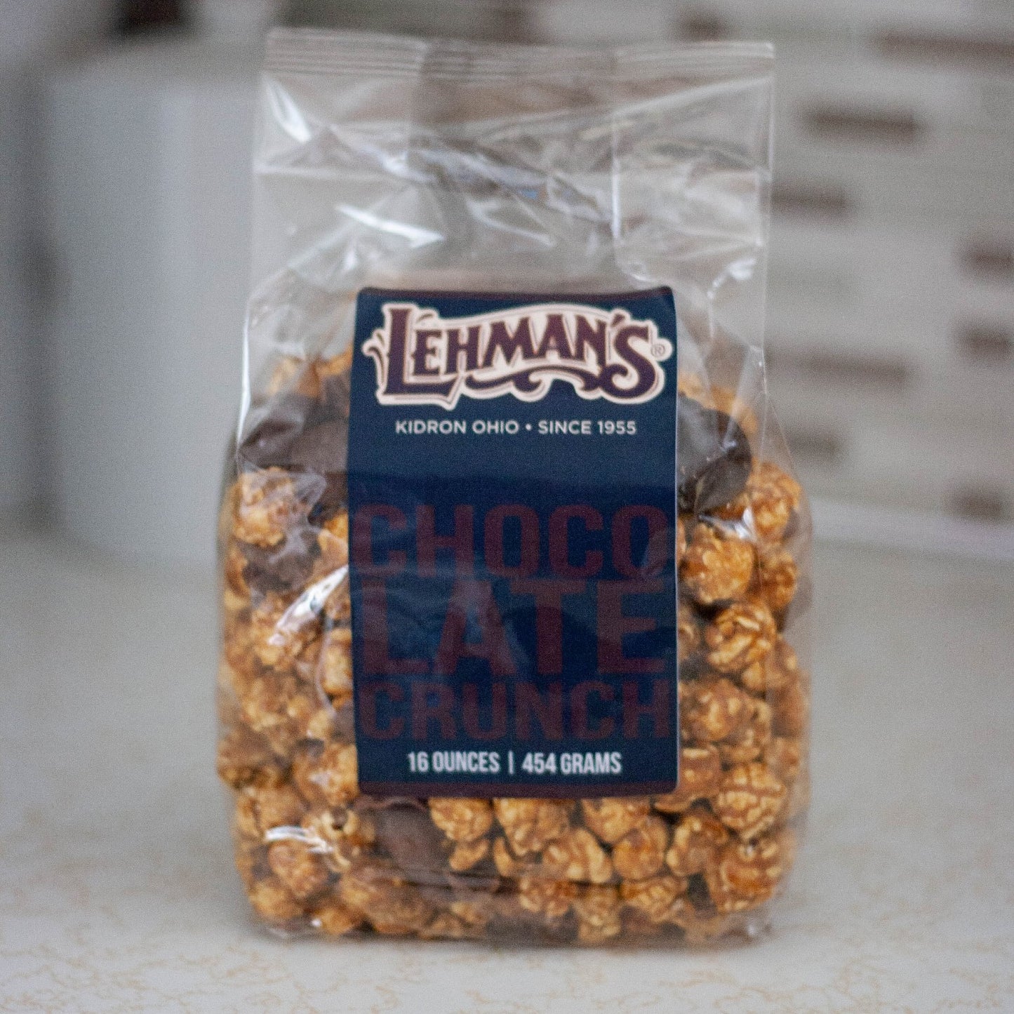 Clear bag of handcrafted Lehman's caramel popcorn crunch with chocolate pieces, a unique sweet and crunchy snack made in USA, featured in Kitchen & Food, Snacks and Sweets, Popcorn, USA Made, and Best Sellers collections.