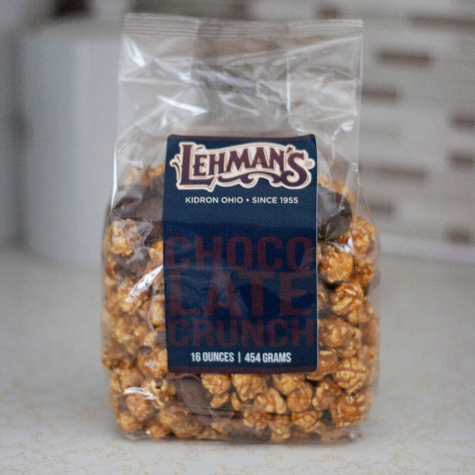 Clear bag of handcrafted Lehman's caramel popcorn crunch with chocolate pieces, a unique sweet and crunchy snack made in USA, featured in Kitchen & Food, Snacks and Sweets, Popcorn, USA Made, and Best Sellers collections.