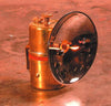 Solid brass carbide lamp with polished reflector and flint striker, handcrafted for reliable white light, ideal for camping, barn, and outdoor use in lamps and lighting collections.