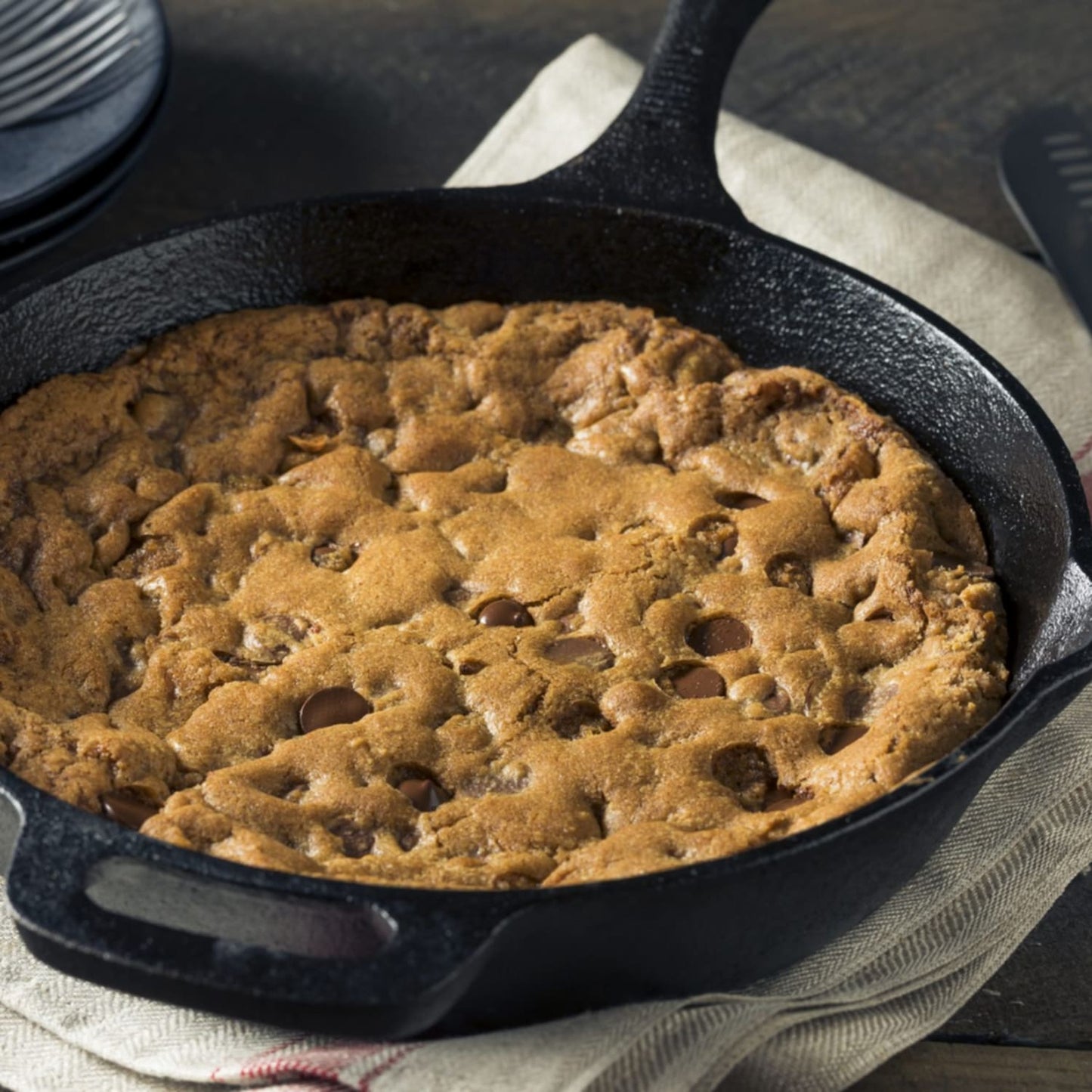 Handcrafted chocolate chip cookie baked in a 6-inch cast iron skillet, styled on a rustic cloth, perfect for Kitchen & Food, Dry Goods and Mixes, Best Sellers, Promo Eligible collections.