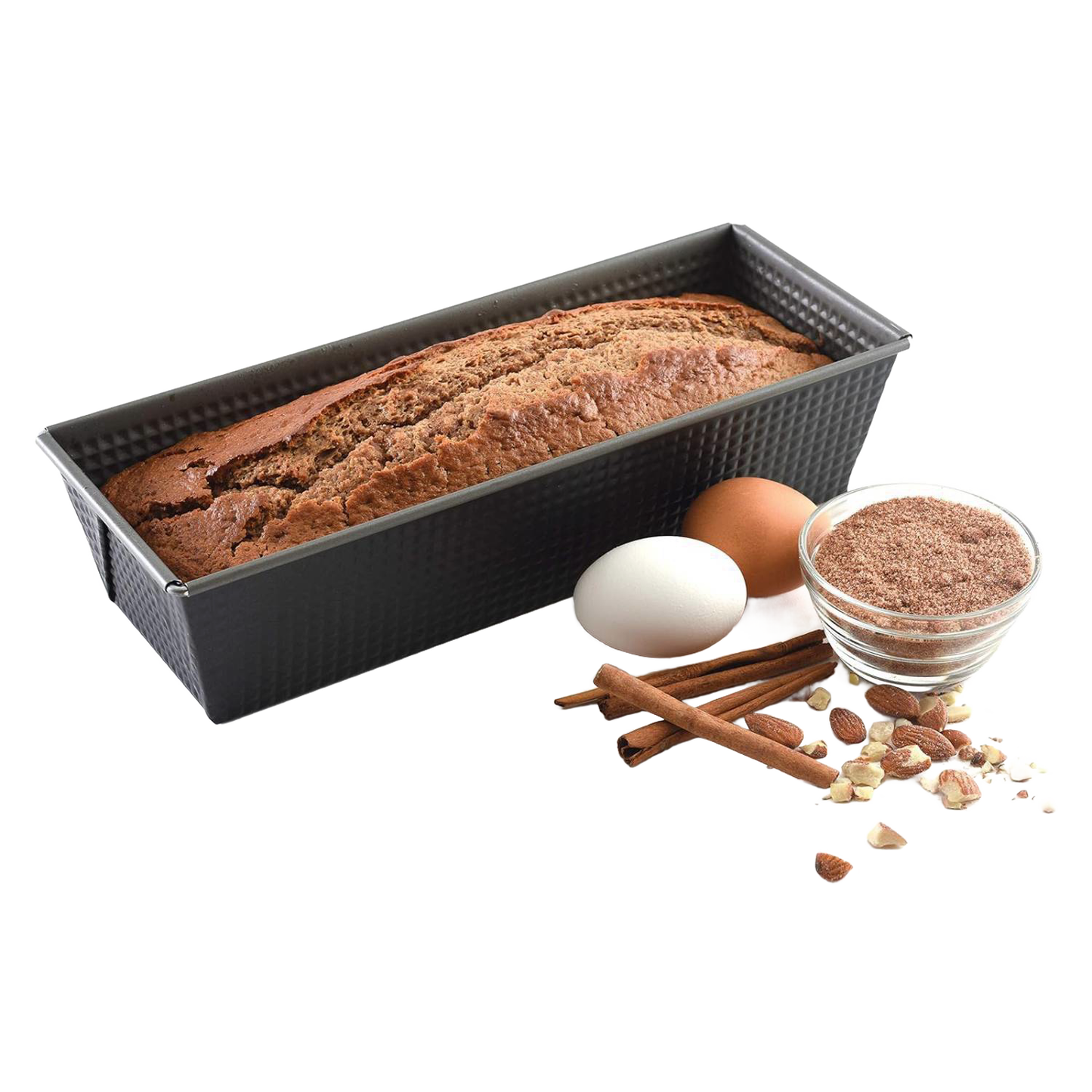 Rectangular heavy gauge steel loaf pan with nonstick textured surface showing baked bread inside, accompanied by eggs, cinnamon sticks, nuts, and a small bowl of brown flour for Kitchen & Food and Baking Supplies collections.