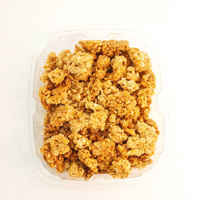 Plastic container filled with crunchy peanut butter granola clusters, showcasing a golden brown texture, featured in Kitchen & Food, Pantry, Dry Goods and Mixes, and USA Made collections.