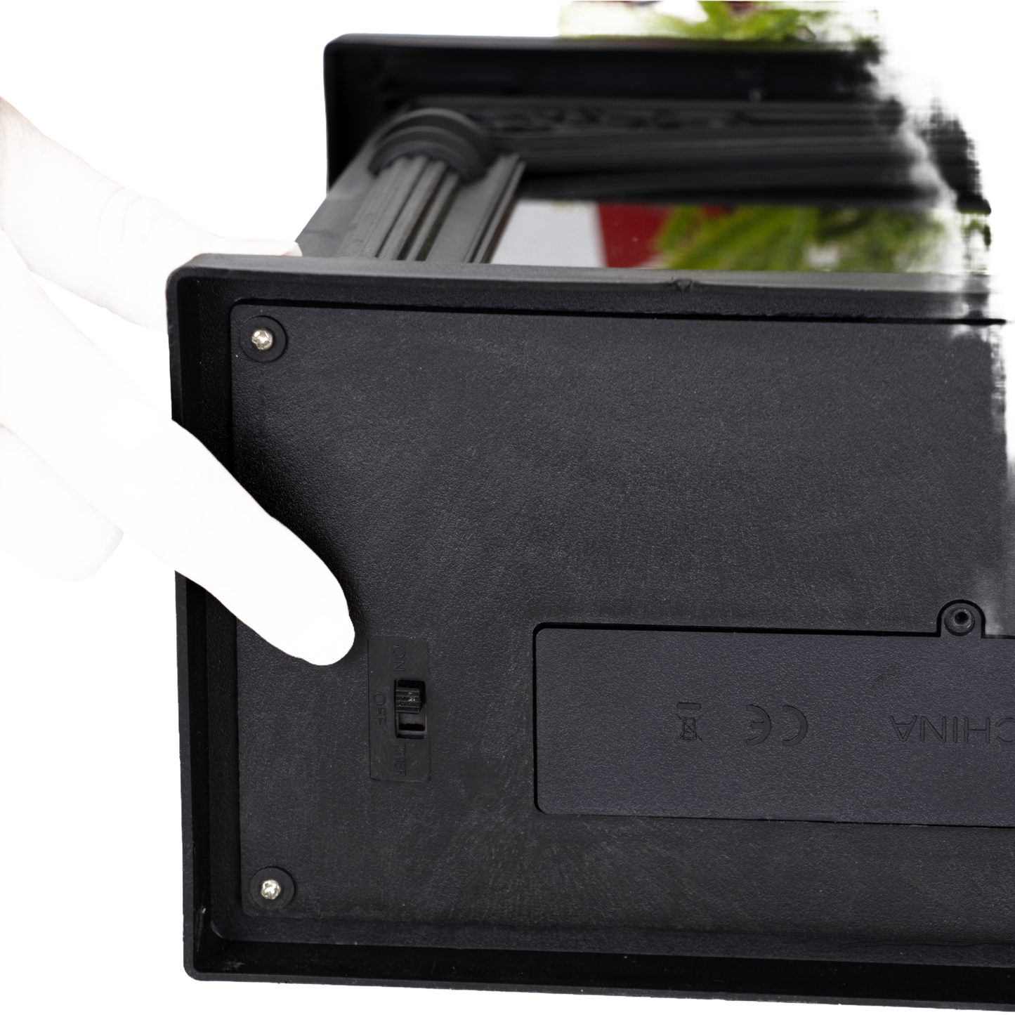 Finger adjusting the small switch on the side of a handcrafted decorative glowing fireplace, battery operated, ideal for Home & Decor, Holiday Decor, Best Sellers, and Promo Eligible collections.