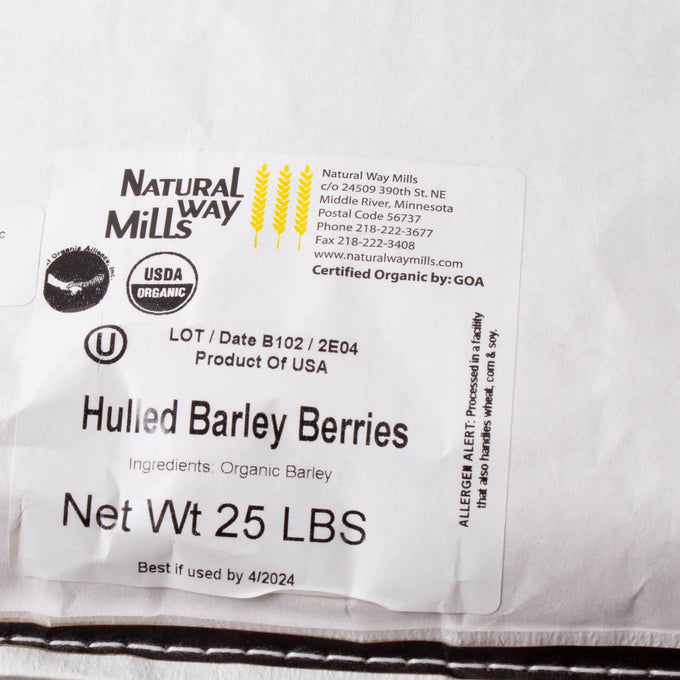 White bag labeled with organic hulled barley berries, showing 25-pound net weight and USDA organic certification, suitable for pantry, farm, and emergency food supplies collections.