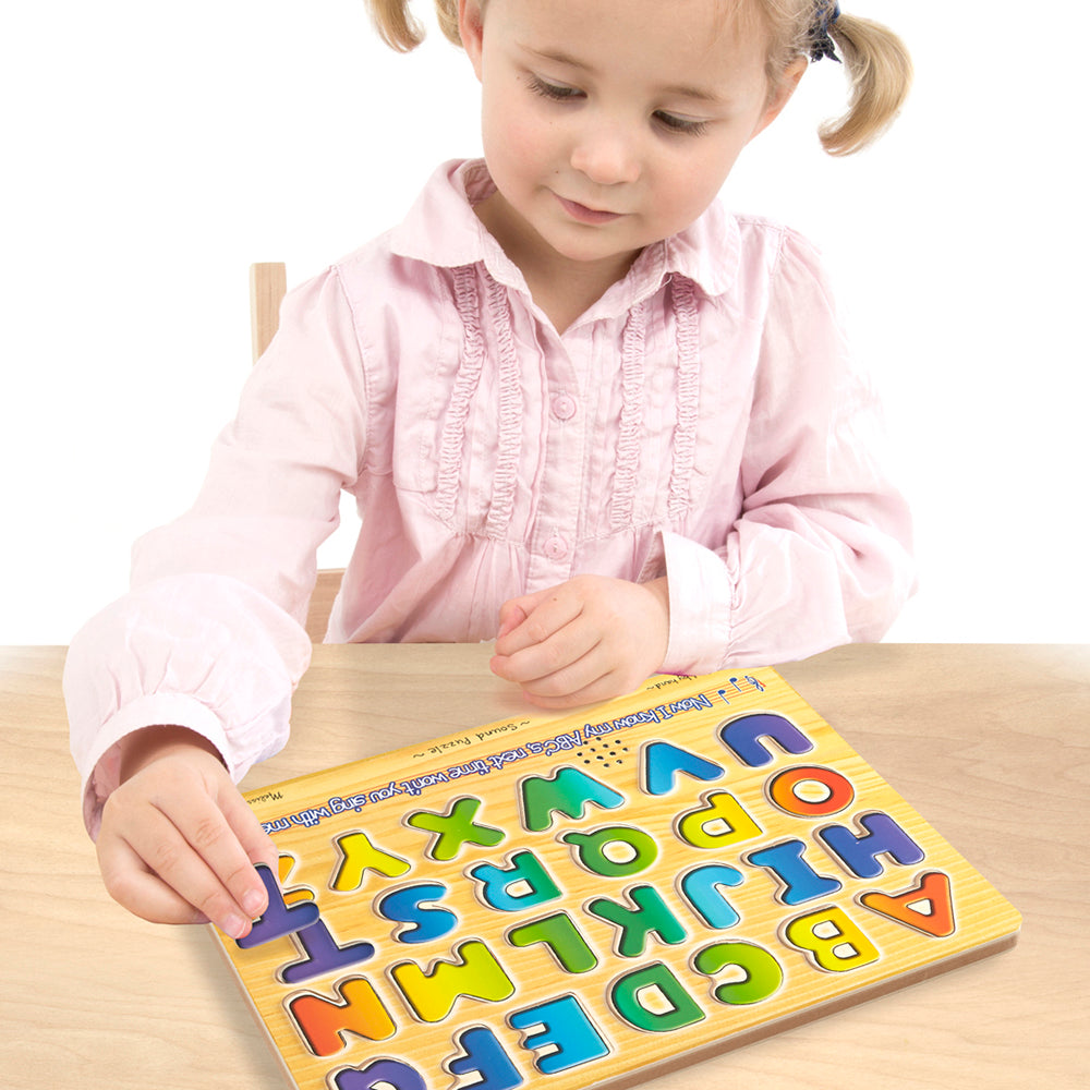 Young child playing with a colorful wooden Alphabet Sound Puzzle featuring raised letters that pronounce each letter when placed, part of Toys, Children's Toys, and Puzzles collections.