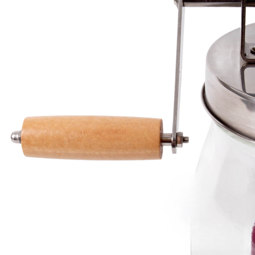 Close-up of a smooth wooden handle and metal crank attached to a glass and stainless steel butter churn, handcrafted for home butter making in Farm, Garden & Tool and Specialty Equipment collections.