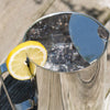 Shiny stainless steel pitcher with built-in ice guard filled with ice cubes and garnished with a fresh lemon slice, featured in Kitchen & Food and Dinnerware collections.
