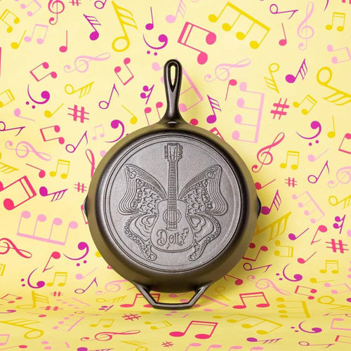 12-inch cast iron skillet featuring a butterfly and guitar design with "Dolly" lettering, handcrafted in USA, ideal for Kitchen & Food, Cookware, Cast Iron, USA Made, Best Sellers, and Promo Eligible collections.