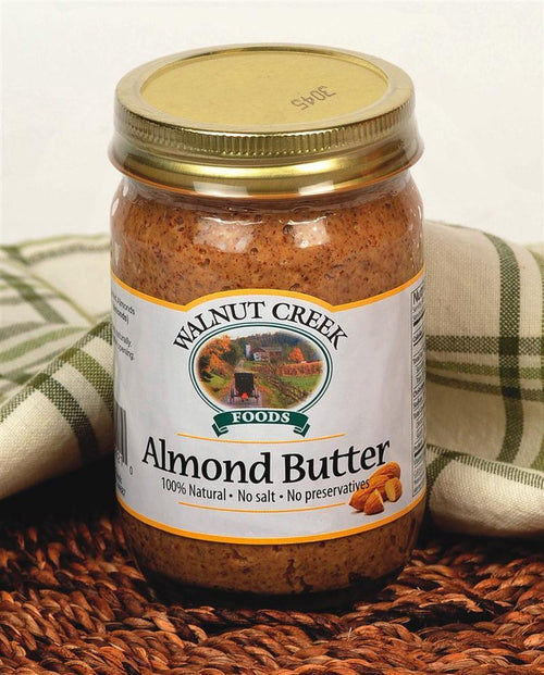 Jar of all-natural almond butter with no salt or preservatives, displayed with rustic fabric and almonds, perfect for Kitchen & Food, Food, and Best Sellers collections.