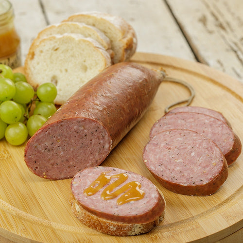 Handcrafted summer sausage from Amish Country with a smoky, savory blend of pork and beef, sliced and served on bread with honey, perfect for Kitchen & Food, Snacks and Sweets, and USA Made collections.