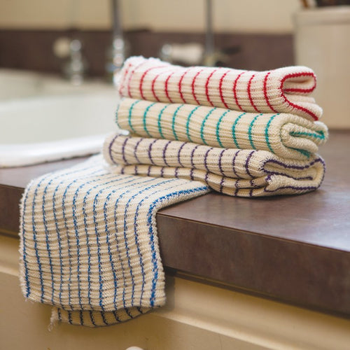Stack of four thick, double-layer striped dishcloths in red, aqua, purple, and blue laid on a kitchen counter, handcrafted and made in USA, ideal for Kitchen & Food and Kitchen Textiles collections.