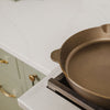 Close-up of a handcrafted, lightweight cast iron skillet with smooth cooking surface and marked size 12, resting on a gas stove in a modern kitchen, ideal for Farm, Garden & Tool, Kitchen & Food, Camping, Cookware, Cast Iron, USA Made, and Best Sellers collections.